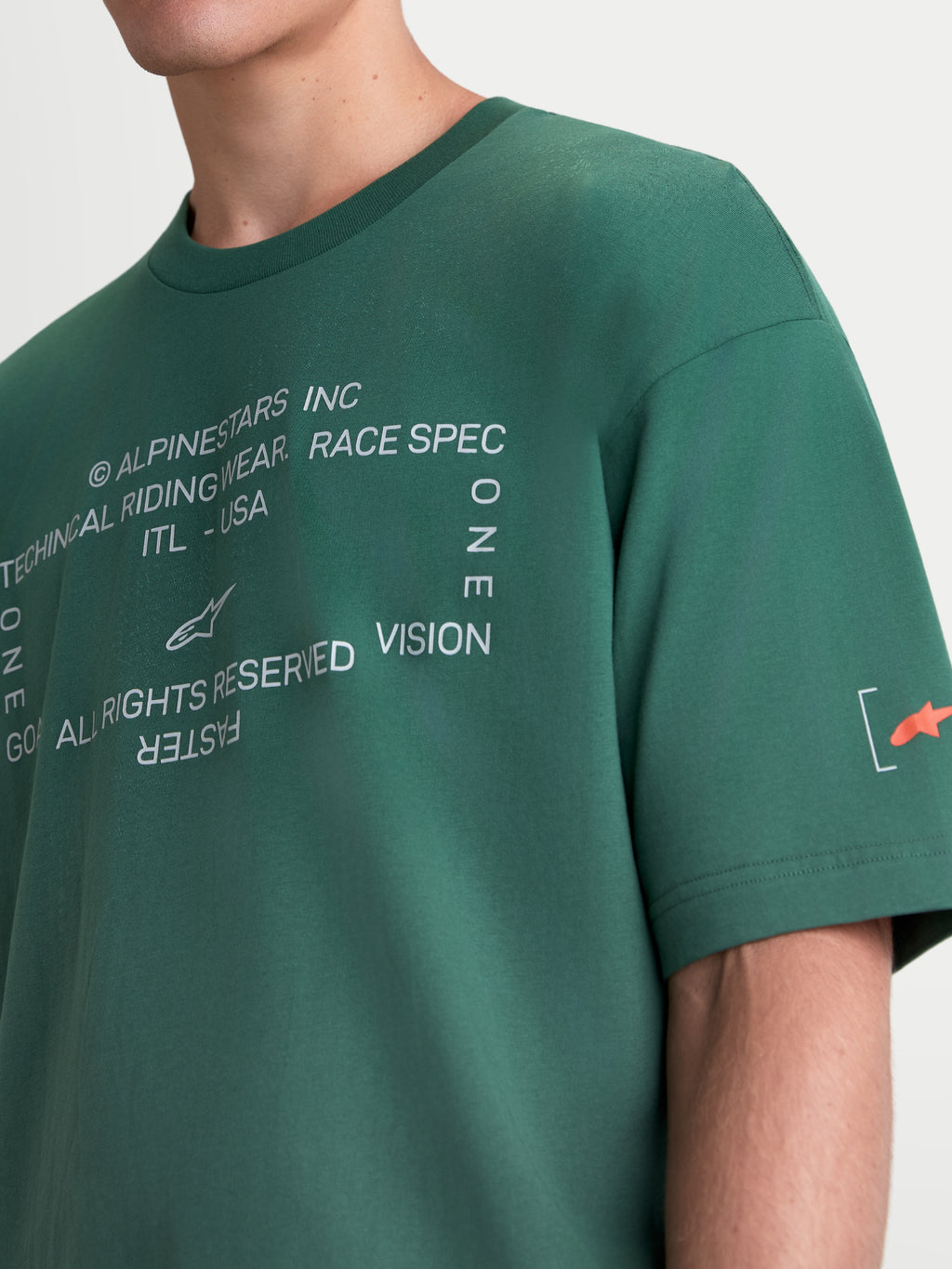 Alpinestars Infinity Oversized CSF T-shirt, grön kortärmad t-shirt i sportswear-stil, vit textgrafik på bröstet och orange Astars-logotyp på ärmen, mjuk bomulls-polyblandning för vardagsbruk.