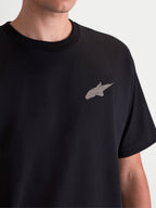Alpinestars Checkback Oversized CSF Tee, Black Sportswear Short Sleeve T-Shirt, featuring a front Astars logo with a distressed soft-hand print, oversized fit for casual everyday wear, close-up chest detail on model.