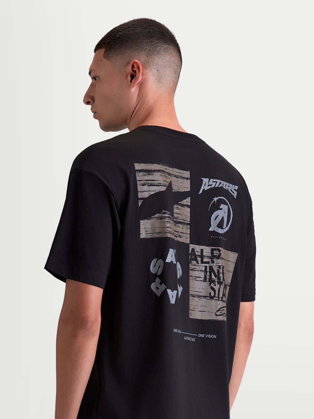 Alpinestars Checkback Oversized CSF Tee, Sportswear Short Sleeve T-Shirt, Black with a bold grey and white collage-style back graphic featuring the Astars logo, relaxed oversized fit.