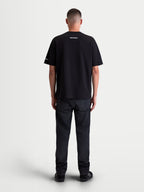 Alpinestars Mandate Oversized CSF Tee, Men's Sportswear Short Sleeve T-Shirt, Black with white graphics, back view showing relaxed oversized fit and small wordmark branding on the neck and sleeve, 60/40 cotton-poly blend.