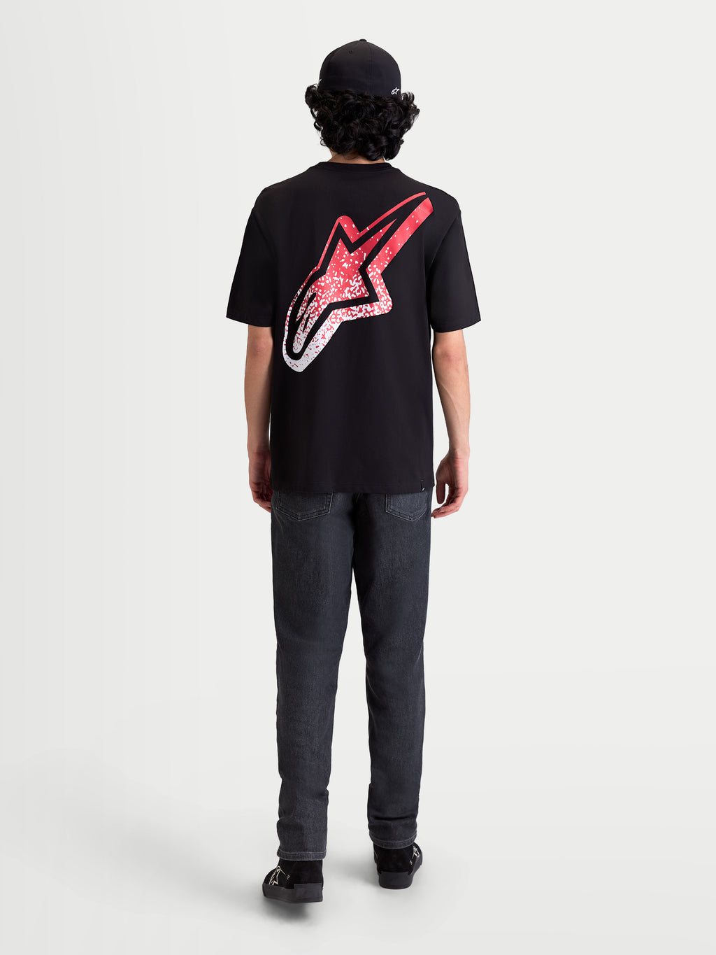 Alpinestars Meteor CSF Tee, Short Sleeve Sportswear T-Shirt, Black, Red, and White. On-model rear view featuring a large back Astars logo with an MX-inspired red and white gradient graphic.