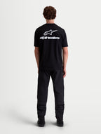 Alpinestars Combo Back CSF t-shirt, svart kortärmad t-shirt med stor vit Astars-logotyp och grafik på ryggen, premium bomulls- och polyesterblandning för motorsportinspirerad stil, ryggvy på modell.