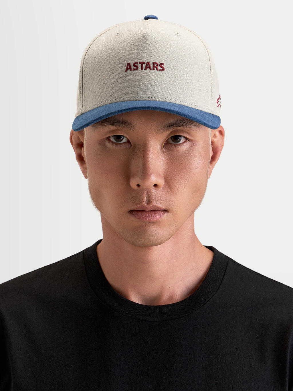 Alpinestars County Canvas Hat, casual sportswear cap worn by a model, sand and blue with embroidered Astars front and side logos, structured crown and curved bill