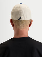 Alpinestars County Canvas Hat, casual sportswear cap, rear view worn by a model showcasing flex-back fit and subtle back label branding, sand and blue, oxford peached cotton fabric