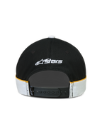 Alpinestars 500 Snapback keps, sportswear lifestyle-keps, svart och vit med gula accenter, justerbar snapback-stängning, sedd bakifrån med vit broderad Astars-logotyp och skär-och-sy-detaljer med kontrasterande passpoaler
