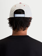 Alpinestars Stadium Snapback keps, vit och röd livsstilskeps, har en justerbar snapback-knäppning och strukturerad krona, bild bakifrån på modell som visar passform för en motorsportinspirerad vardagsstil.
