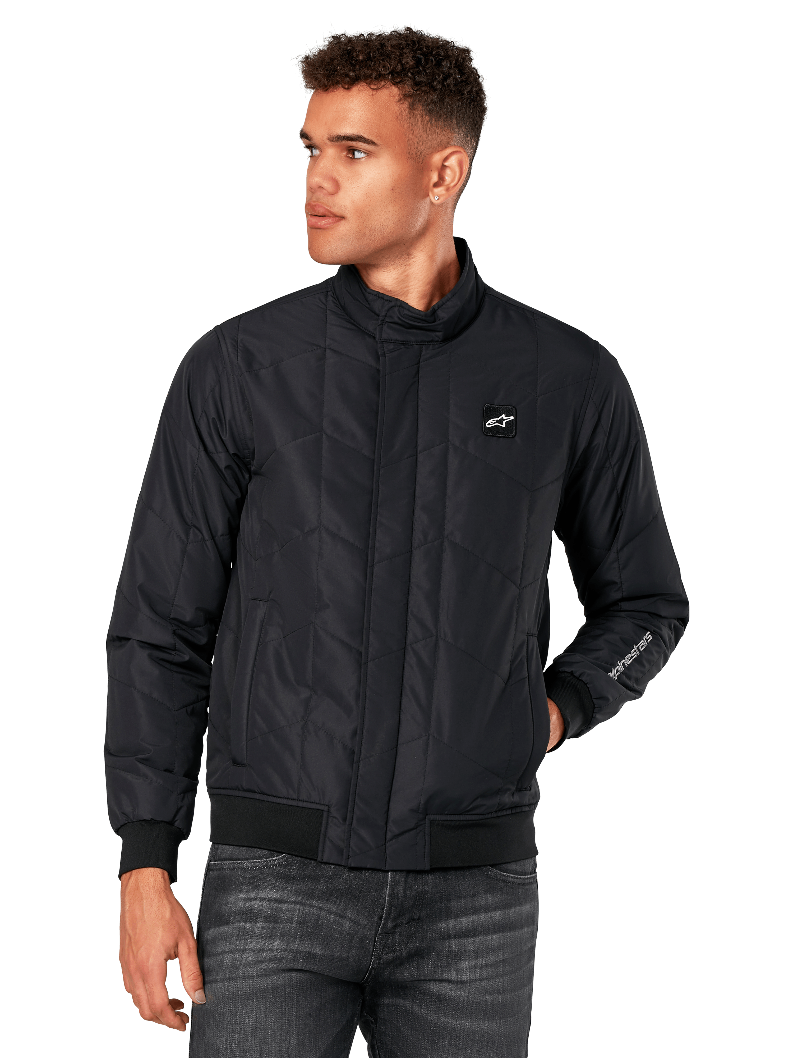 Alpinestars Precedent Jacket, svart quiltad jacka med vinklat mönster, Formula 1-styling, låg ståkrage, ribbade muddar och nederkant, logomärke på bröstet, broderi på ärmen, motorsport-inspirerad lifestyle streetwear