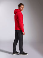 Alpinestars Ride V3 Hoodie, casual sportswear, Red with Hi-Vis Yellow branding, male model wearing red hoodie with black pants and sneakers, side profile view, pullover fleece design with ribbed cuffs and hem.