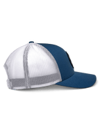 Alpinestars Gambit Trucker Hat, Blue and White, side profile view, curved bill with structured crown, blue twill front panels and white poly mesh back, casual motorsport-inspired headwear