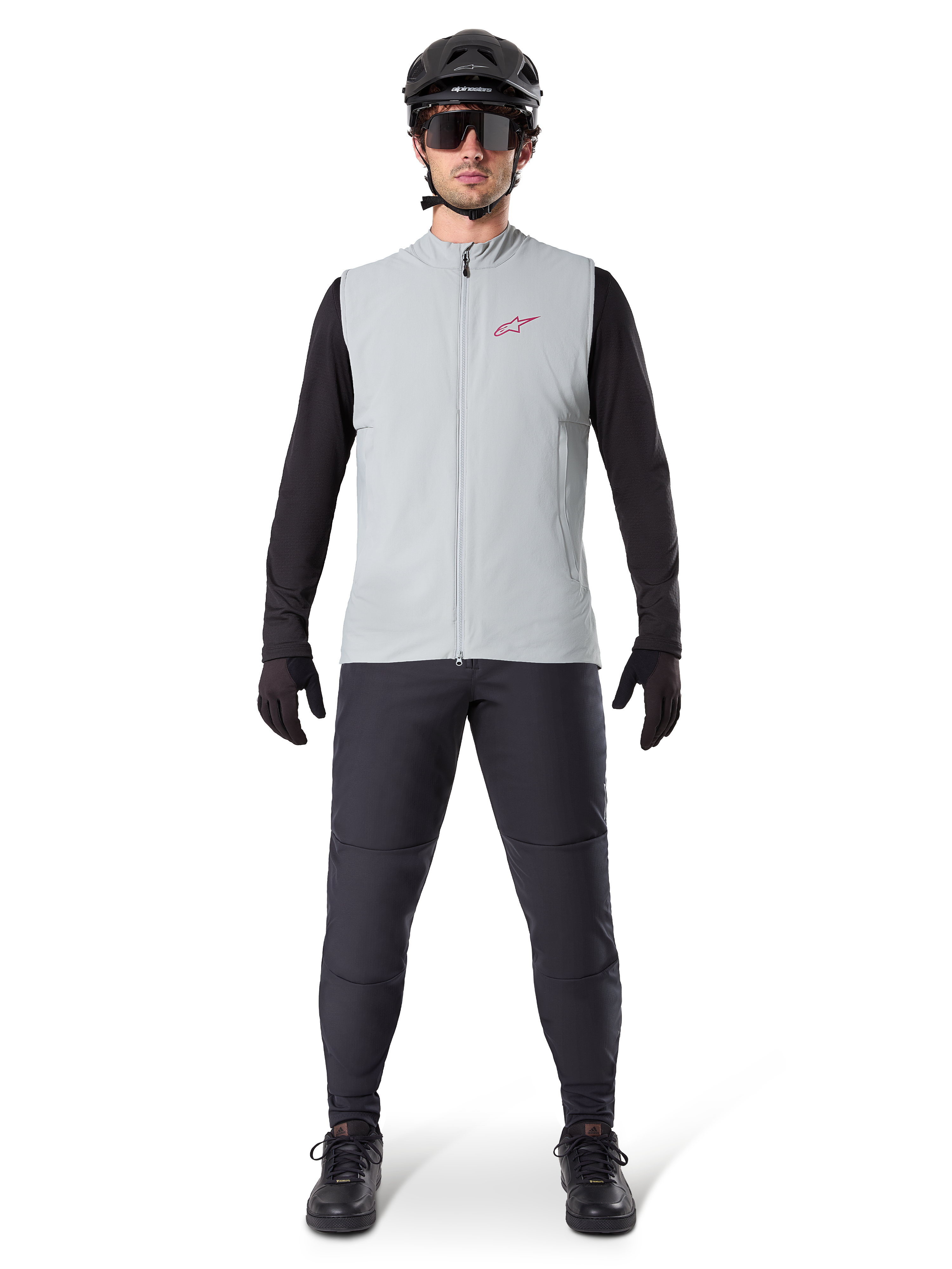 Alpinestars A-Dura Thermal Vest, cykelväst, Titanium Gray, bärs med svart långärmad tröja och svarta byxor, svart hjälm och solglasögon, röd Alpinestars-logotyp, lätt termisk isolering för mountainbike