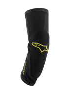 Alpinestars Paragon Plus knäskydd, svarta med syragula logotyper, skyddsutrustning för mountainbike, tubformad slip-on-modell med integrerad vaddering, ventilerande mesh och slitstarkt texturerat tyg