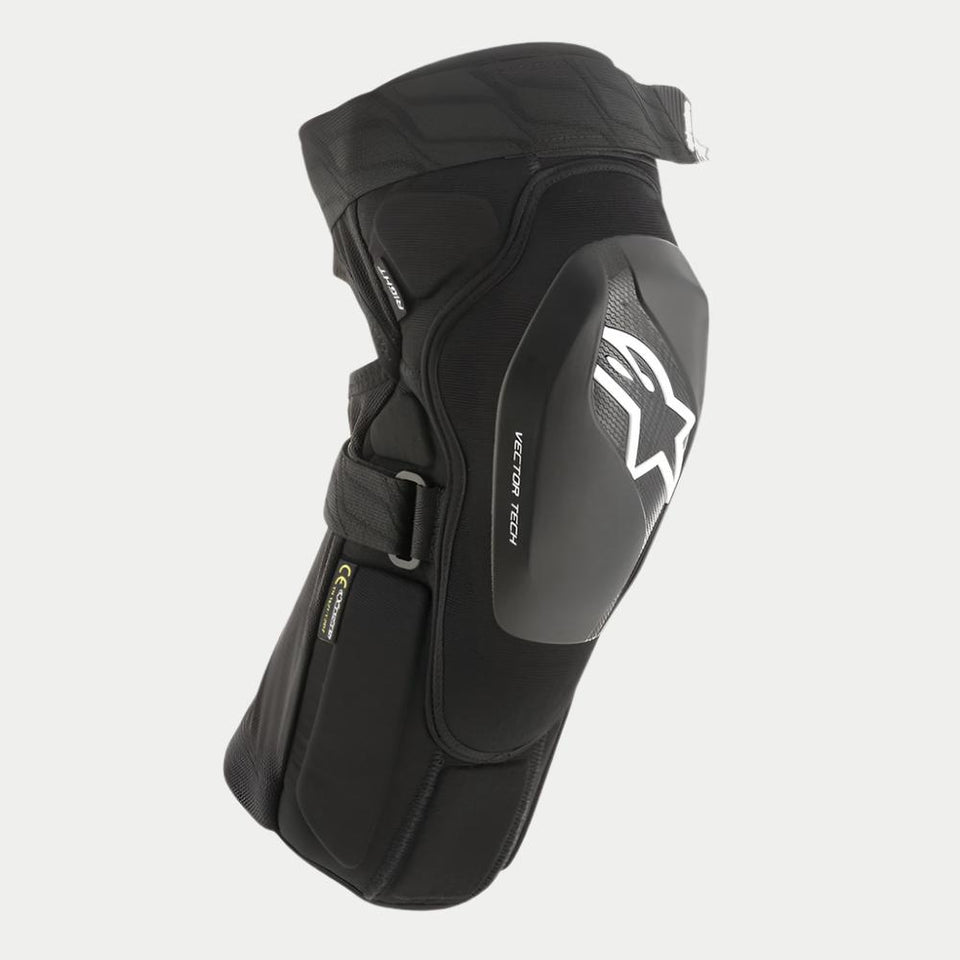 Alpinestars Vector Tech knäskydd, svarta MTB-knäskydd, halvstyvt skal med vit Astar-logotyp och Vector Tech-branding, ergonomisk kompressionspassform med justerbara remmar, lätt skyddsutrustning för terrängkörning