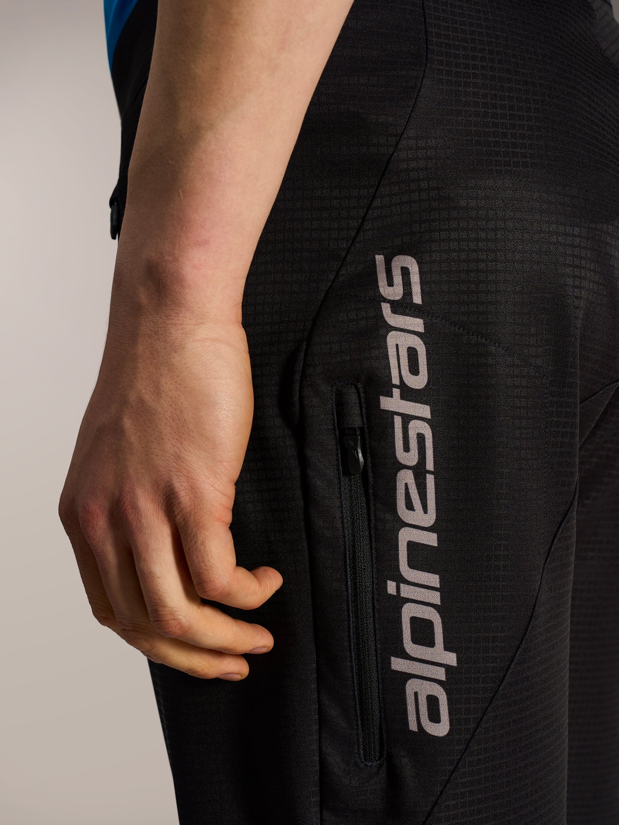 Black A-Dura Elite Flex Shorts featuring ripstop fabric, a vertical zippered pocket, and grey Alpinestars logo.