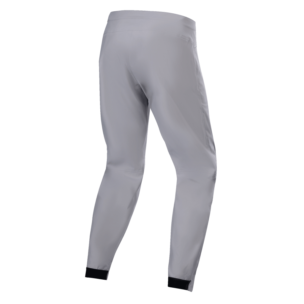 Alpinestars A-Dura Waterproof Pants, MTB-byxor, titaniumgrå, baksida, avsmalnande ben med svarta elastiska muddar, minimalistisk teknisk design för mountainbike