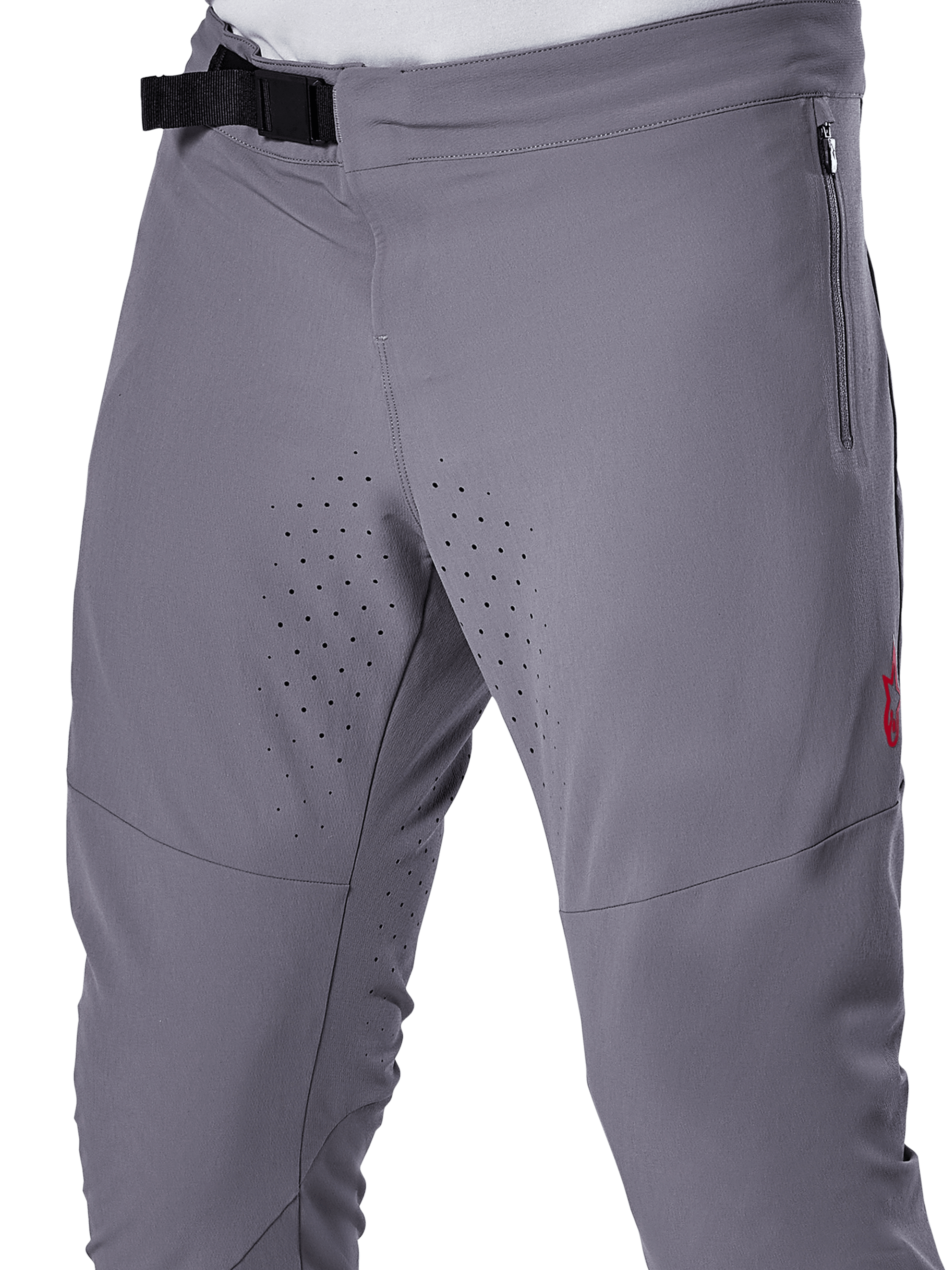 Alpinestars A-Aria Elite byxor, MTB-cykelbyxor, mörkgrå, närbild som visar magnetiskt spänne, blixtlåsförsedd sidoficka och laserskurna ventilationsperforeringar på innerlåren för prestanda vid trailcykling