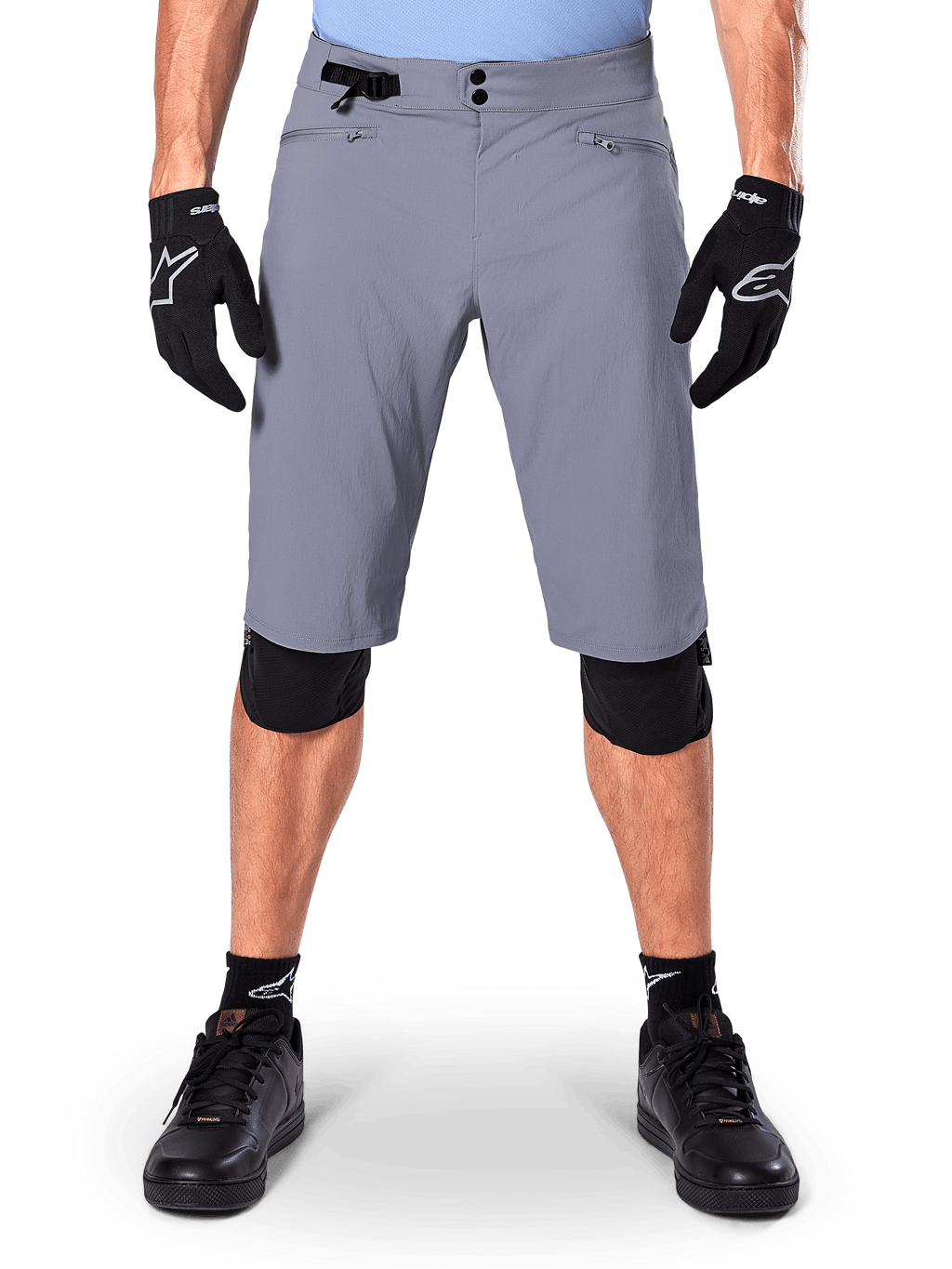 Alpinestars A-Dura Shorts, mountainbikeshorts, mörkgrå, bärs med svarta Alpinestars-handskar och knäskydd, med dubbel tryckknappsstängning och dragkedjeförsedda nätfodrade fickor, slitstarkt 2-vägsstretchtyg för terrängcykling