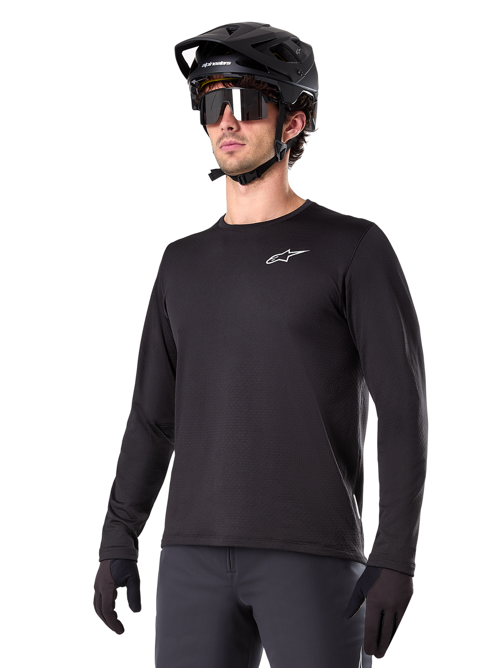 Alpinestars A-Dura Thermal Jersey, svart långärmad mountainbiketröja, vit logotyp på bröstet, bärs med svart hjälm och handskar, stilren sportig design för trailcykling