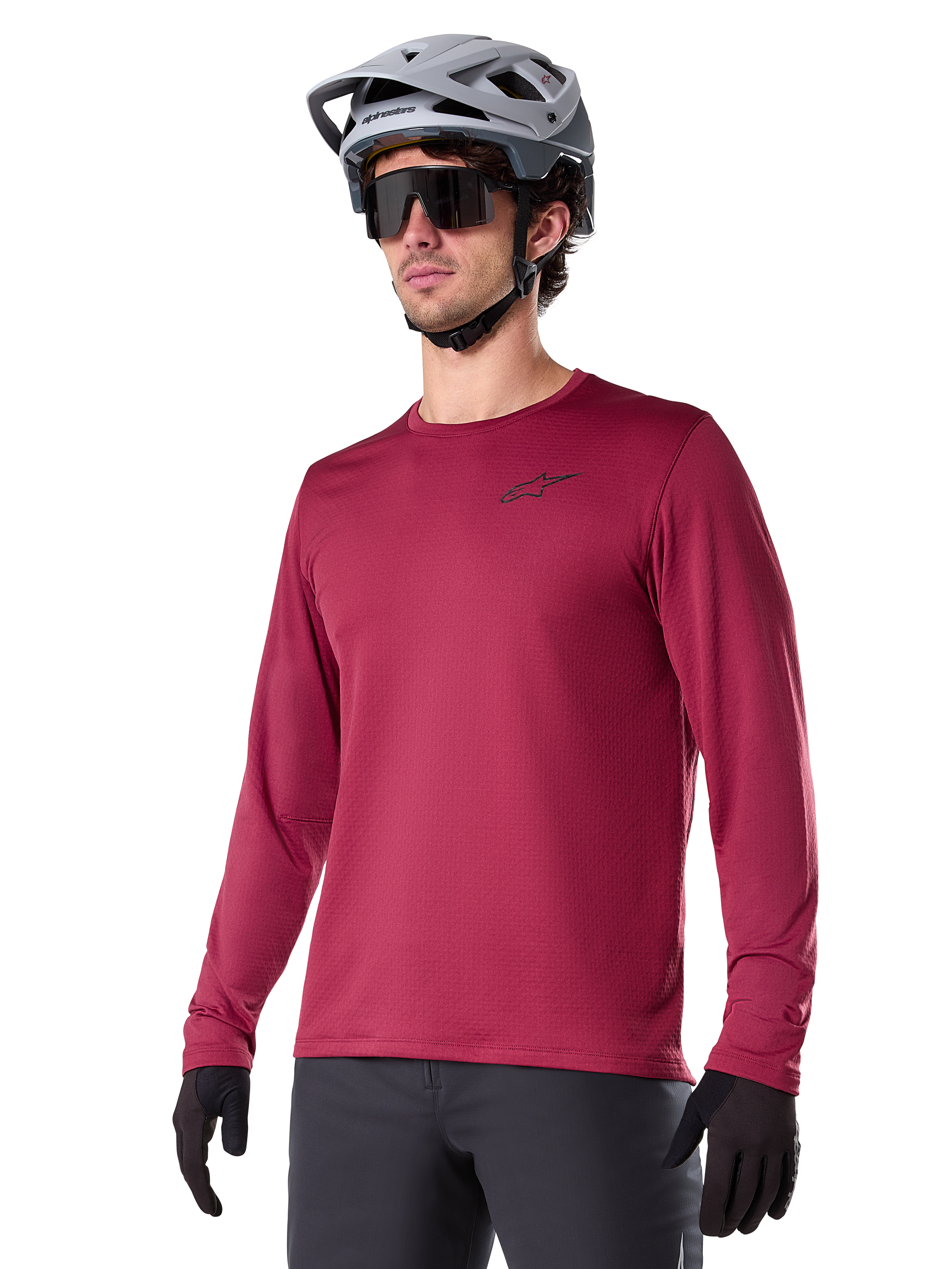 Alpinestars A-Dura Thermal Jersey, långärmad mountainbiketröja, vinröd, med isolerande fleecefoder och en liten svart logotyp på bröstet, bärs med en grå hjälm, svarta solglasögon och svarta handskar, designad för cykling i kallt väder