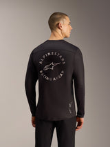 Svart Alpinestars A-Dura Air långärmad tröja, ryggvy med cirkulär Racing Ahead-grafik och ventilerande mesh-tyg.