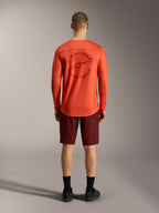 Alpinestars orange long-sleeve MTB jersey and Bordeaux A-Dura Ride Shorts, rear view of technical cycling apparel.