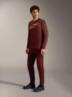 Bordeaux A-Dura Ride Long Sleeve Jersey with yellow Astars logo, styled with matching pants and black cycling shoes.