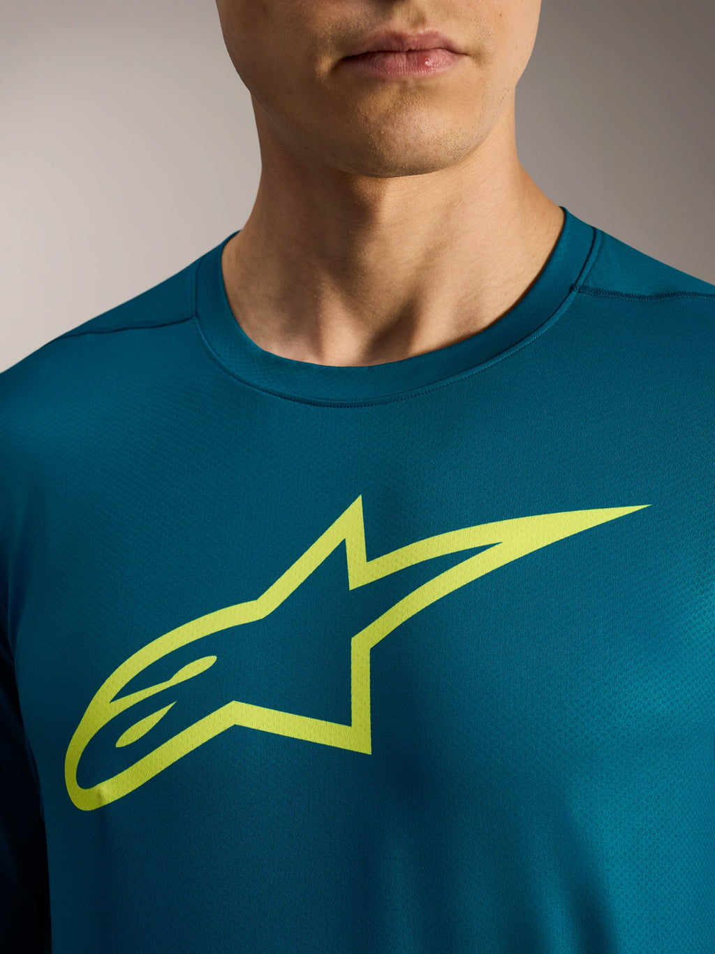 A-Dura Ride långärmad tröja i blågrönt med limegrön Alpinestars-logotyp på bröstet, MTB-utrustning.