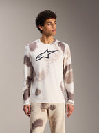 Alpinestars A-Dura Ride långärmad MTB-tröja i Sand Camo, vit design med abstrakta mönster och svart logotyp på bröstet.