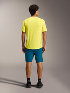 Gul A-Dura Ride SS-tröja med blågröna A-Dura Ride-shorts, sedda bakifrån, funktionell MTB-utrustning.