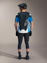 Alpinestars A-Dura Race SS Jersey in blue and black, styled with technical MTB shorts and performance gear.