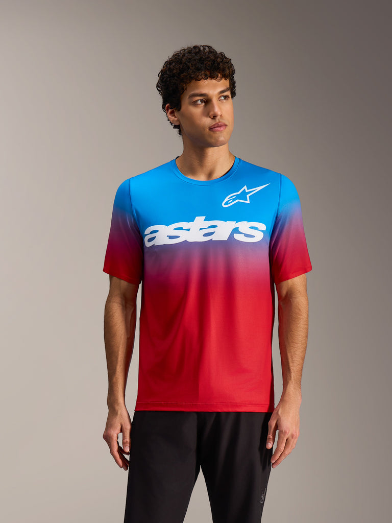 Bright red blue A-Dura ASTARS 2.0 MTB Jersey with a gradient design and bold white logos on a male model.