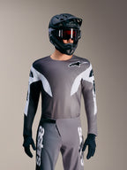 Alpinestars A-Supra Elite Tröja i Faded Gray, mikroperforerad MTB-topp med vita accenter och logotypdetaljer.