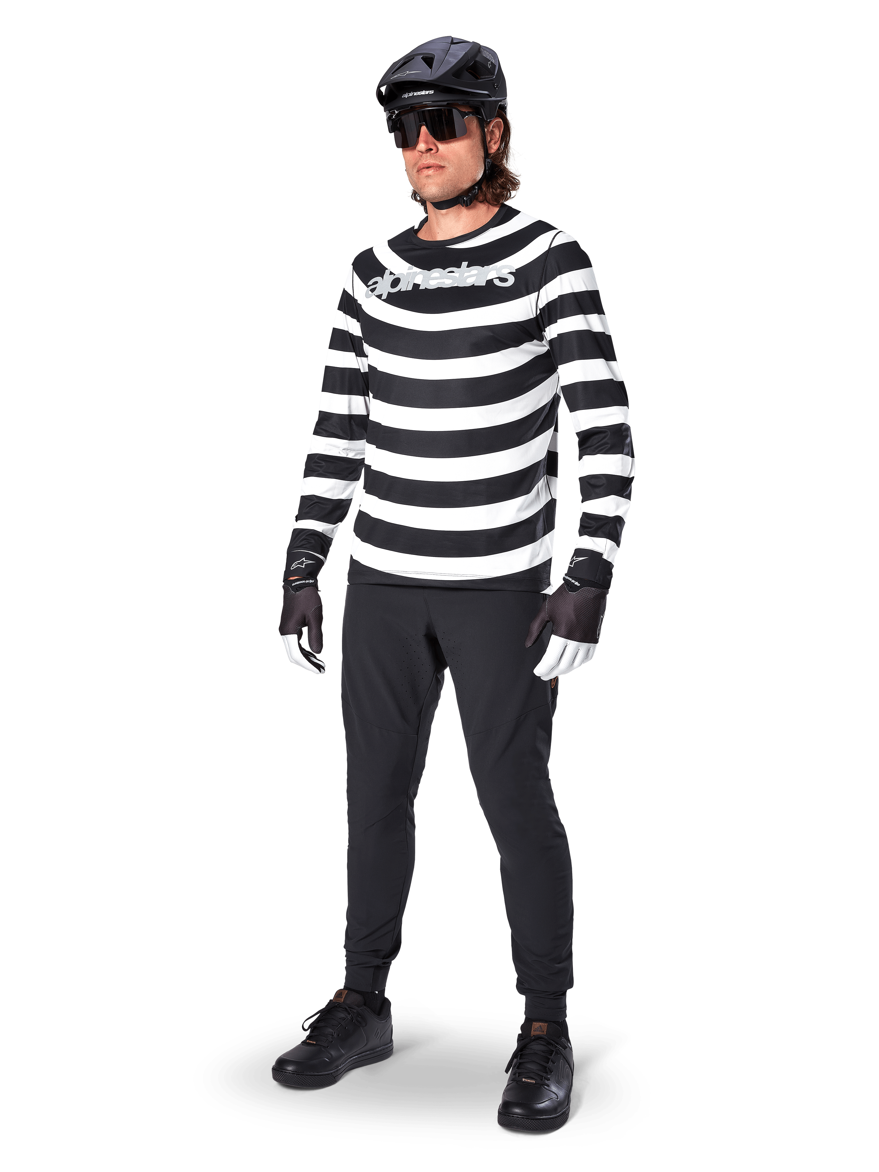 Alpinestars A-Aria Oscar Long Sleeve Jersey, Black and White with bold horizontal spiral stripes, white curved Alpinestars logo, performance MTB apparel worn with black cycling pants and helmet