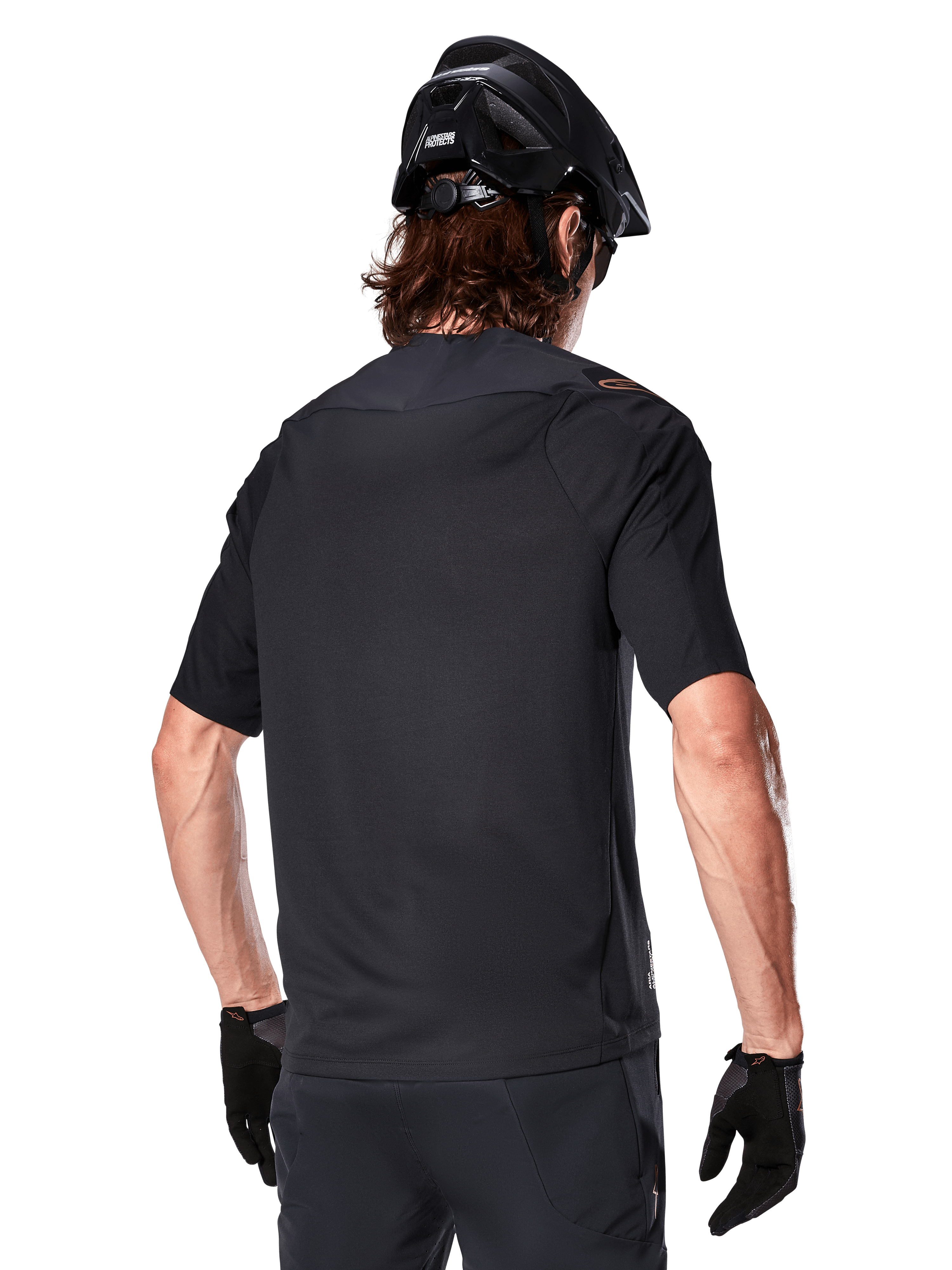 Alpinestars A-Aria Polartec Switch Short Sleeve Jersey, Black, rear view on a rider wearing a black mountain bike helmet, matching black shorts and gloves, performance gear for mountain biking