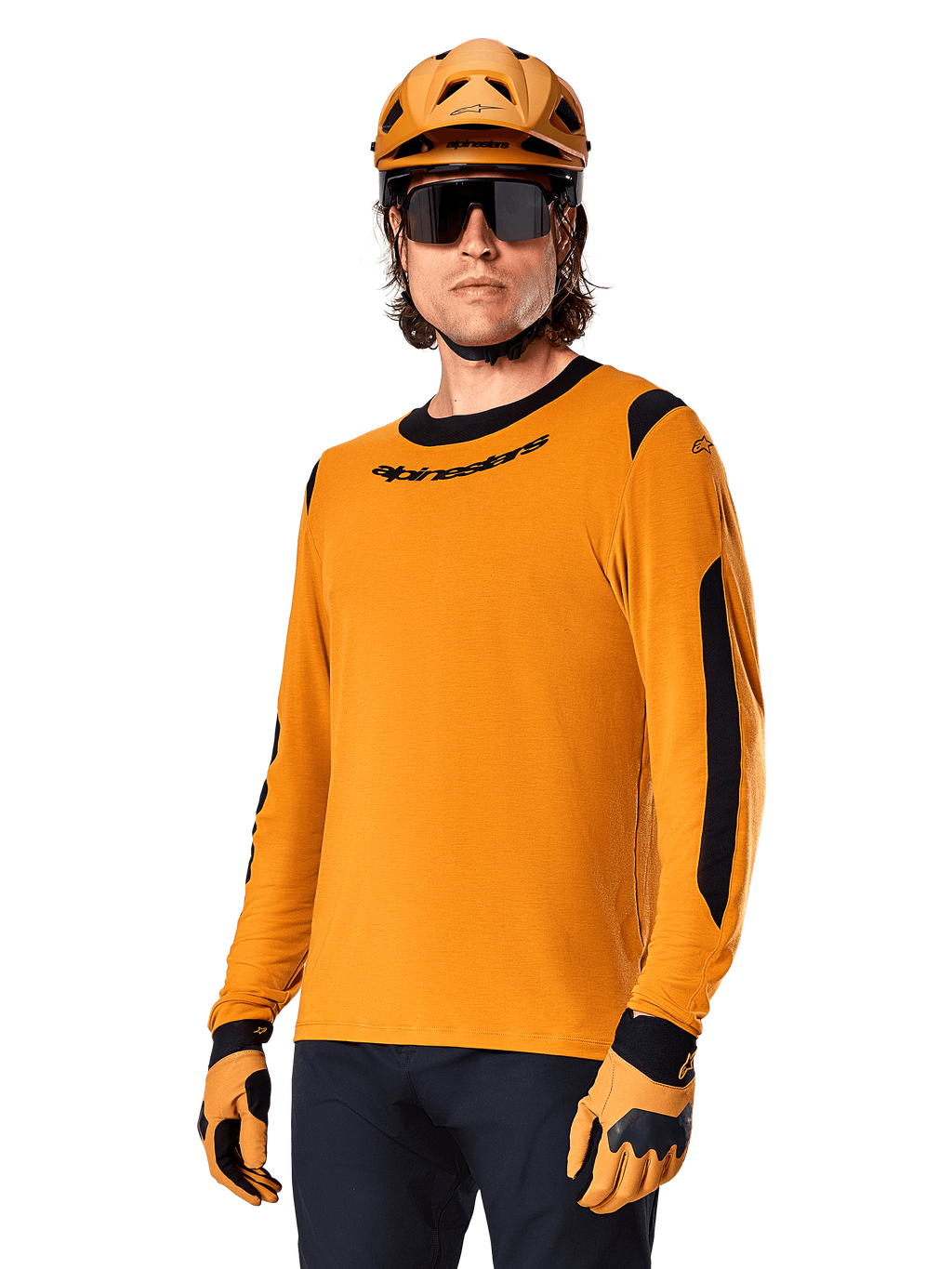 Alpinestars A-Dura Dri Wool Jersey - långärmad tröja, MTB-tröja, mörkguld och svart, med fukttransporterande merinoullsblandning och meshpaneler, person som bär matchande hjälm, solglasögon och handskar