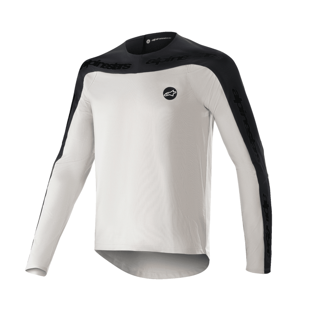 Alpinestars Drop Meta långärmad tröja, MTB-tröja, ljusgrå och svart, med svart axelok och yttre ärmpaneler med textlogotyp, förlängd nederkant baktill för täckning och rund logotyp på vänster bröst