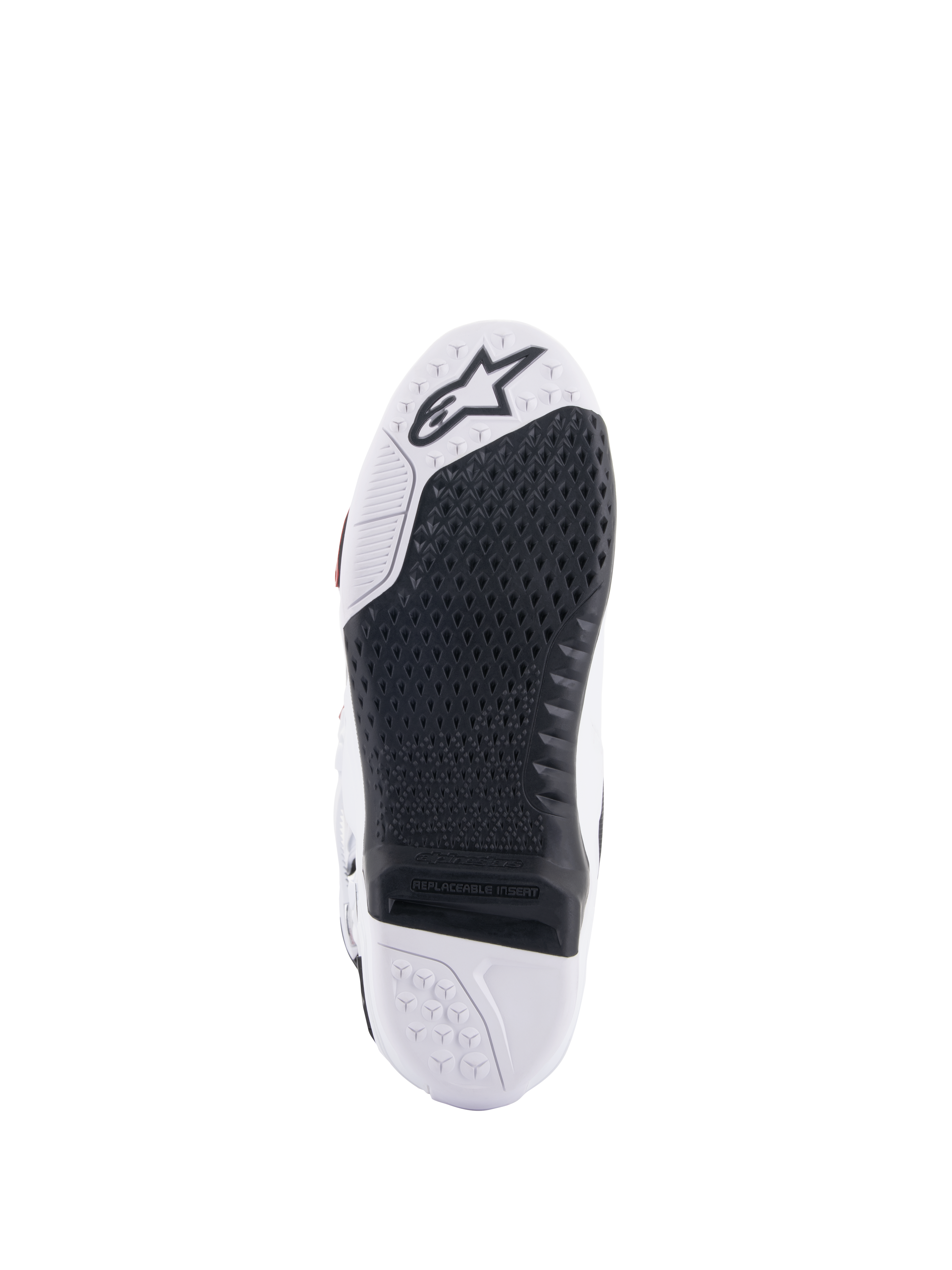 Alpinestars Tech 10 Supervented-stövlar, vy av sula i vitt och svart, med en utökad bikakedesign för grepp, svart utbytbar central insats, vit tå med Alpinestars stjärnlogotyp, optimerad för kontroll på fotpinnarna vid motocross