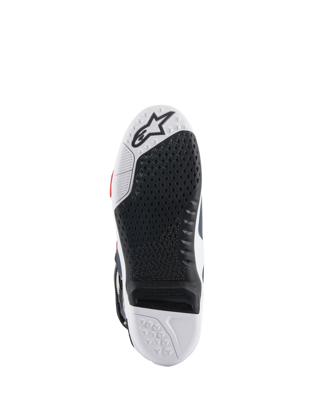 Alpinestars Tech 10 Supervented-stövlar, sula sedd underifrån, svart och vit design i dubbel gummiblandning, bikakeformat greppmönster, utbytbar central sulinsats, präglad Alpinestars-logotyp, optimerad för prestanda på motocross-fotpinnar.