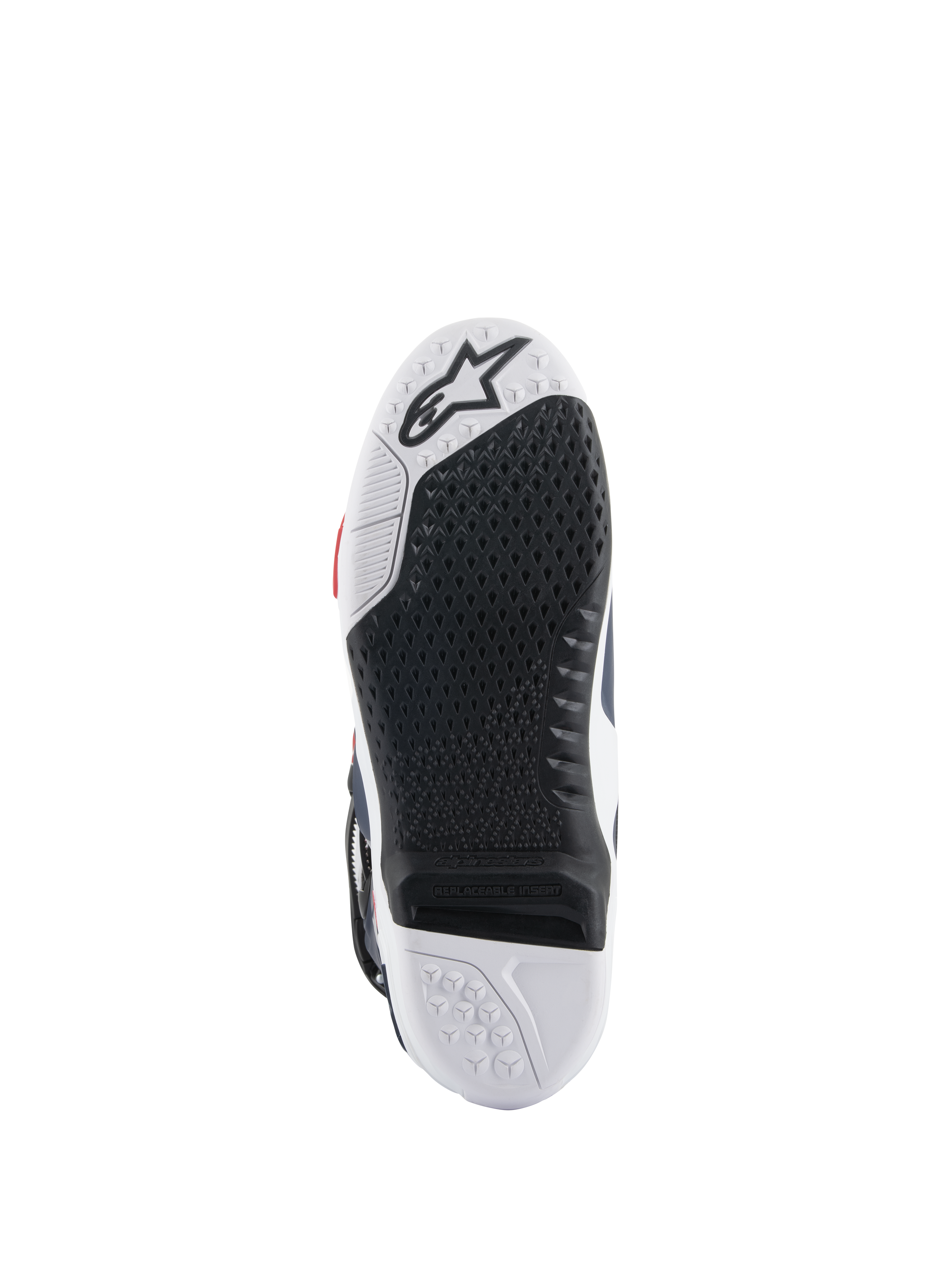 Alpinestars Tech 10 Supervented-stövlar, sula sedd underifrån, svart och vit design i dubbel gummiblandning, bikakeformat greppmönster, utbytbar central sulinsats, präglad Alpinestars-logotyp, optimerad för prestanda på motocross-fotpinnar.