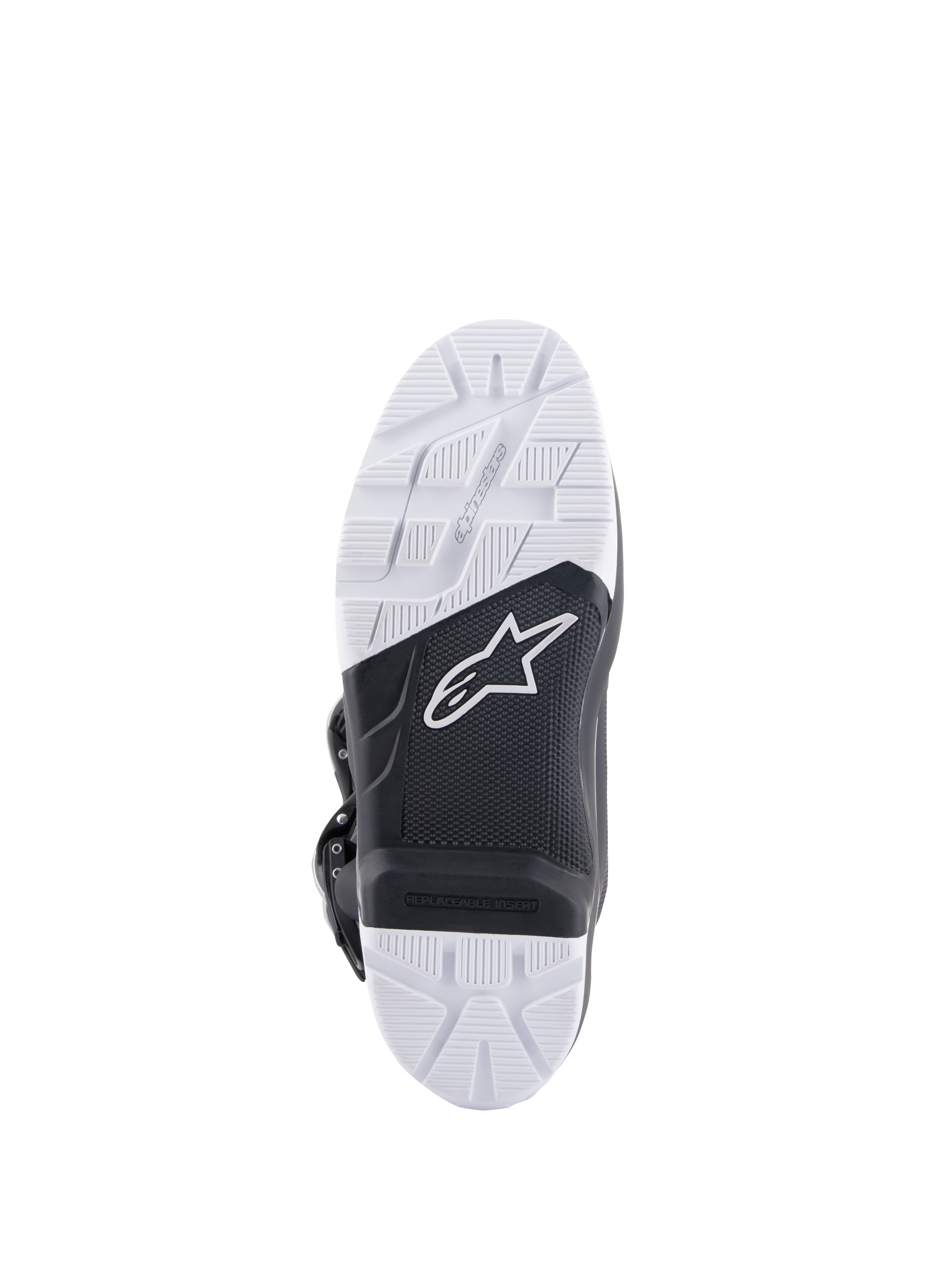 Alpinestars Tech 7 Enduro-stövlar, vy av sulan som visar den specialutvecklade sammansatta slitsulan, svart och vit tvåtonsdesign med texturerat greppmönster, vit stjärnlogotyp och en utbytbar fotpinnsinsats.