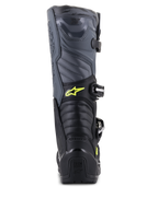 Alpinestars Tech 5-stövlar, motocross-stövlar, svarta, kalla grå och neongula, vy bakifrån som visar dragspelsflexzoner och hälskydd, gul Astars-logotyp och präglad Tech Series-logotyp, hållbar multimaterialkonstruktion för offroad-prestanda