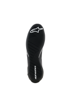 Alpinestars Supertech K Shoes - FIA, Karting Shoes, Black, bottom view showing the ultra-thin rubber outsole with asymmetric tread, white star logo on the forefoot and white brand name on the heel, engineered for maximum pedal feel.
