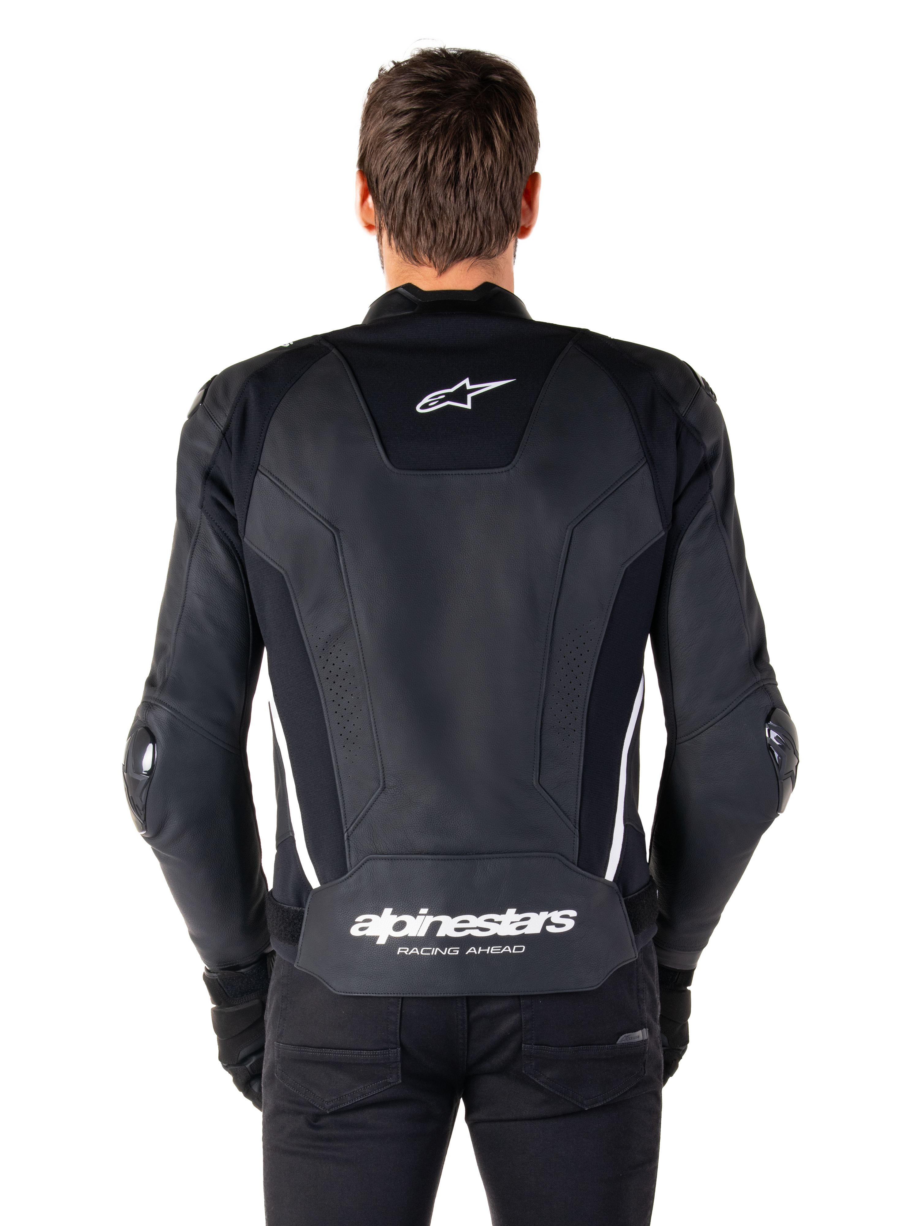 Ryggvy av Alpinestars Missile V3 skinnjacka i svart och vitt, med Alpinestars stjärnlogotyp på övre delen av ryggen och branding på ländryggen, vita vertikala ränder och externa armbågssliders, premium racing-sportjacka i skinn