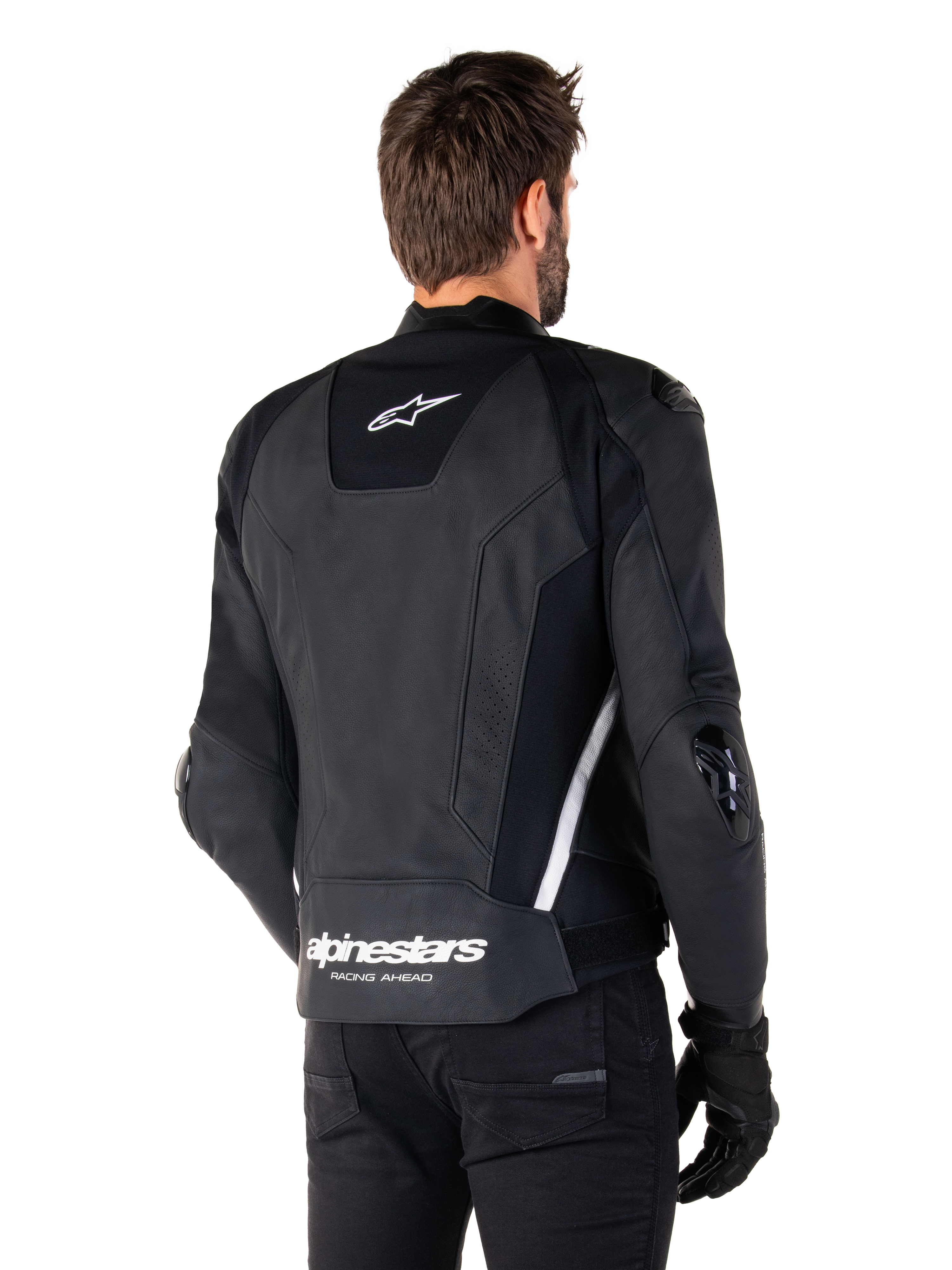 Alpinestars Missile V3 skinnjacka, baksida, svart och vit, med Alpinestars stjärnlogotyp på övre ryggen och ordmärke på nedre ryggen, skyddande sliders på armbågar och axlar, förstklassig racingutrustning i läder.