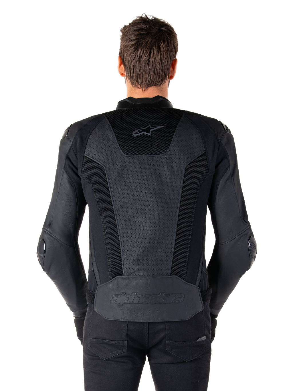 Alpinestars Missile V3 Airflow skinnjacka i svart sedd bakifrån på en modell, som visar omfattande perforerade paneler och mesh-inlägg på ryggen för ventilation, med präglad logotyp på den nedre delen av ryggen.