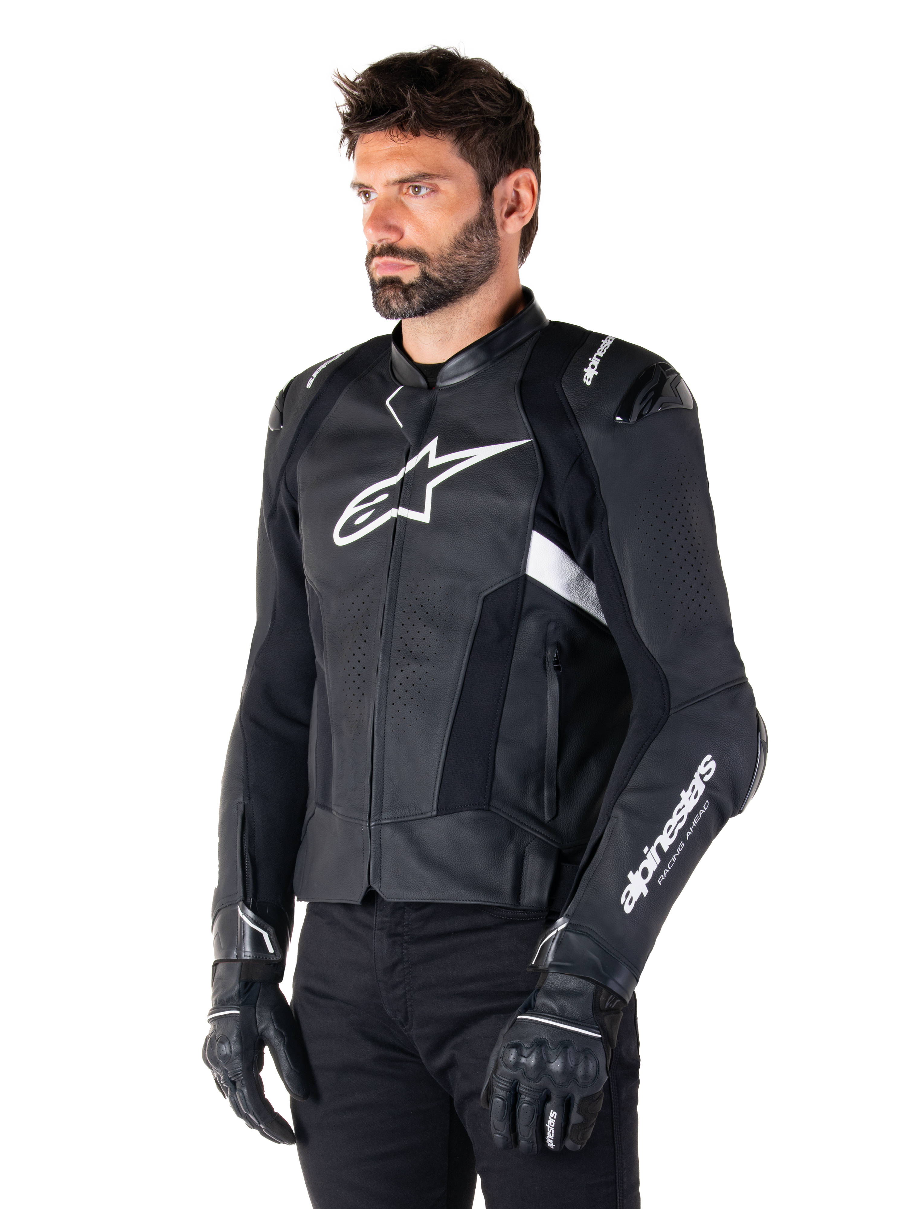 Man som bär Alpinestars Missile V3 Airflow Leather Jacket, svart och vit motorcykeljacka, premiumperforerat läder för luftflöde, vit Alpinestars-logotyp på bröstet och ärmen, racinginspirerad sportpassform, bärs med svarta handskar och byxor.