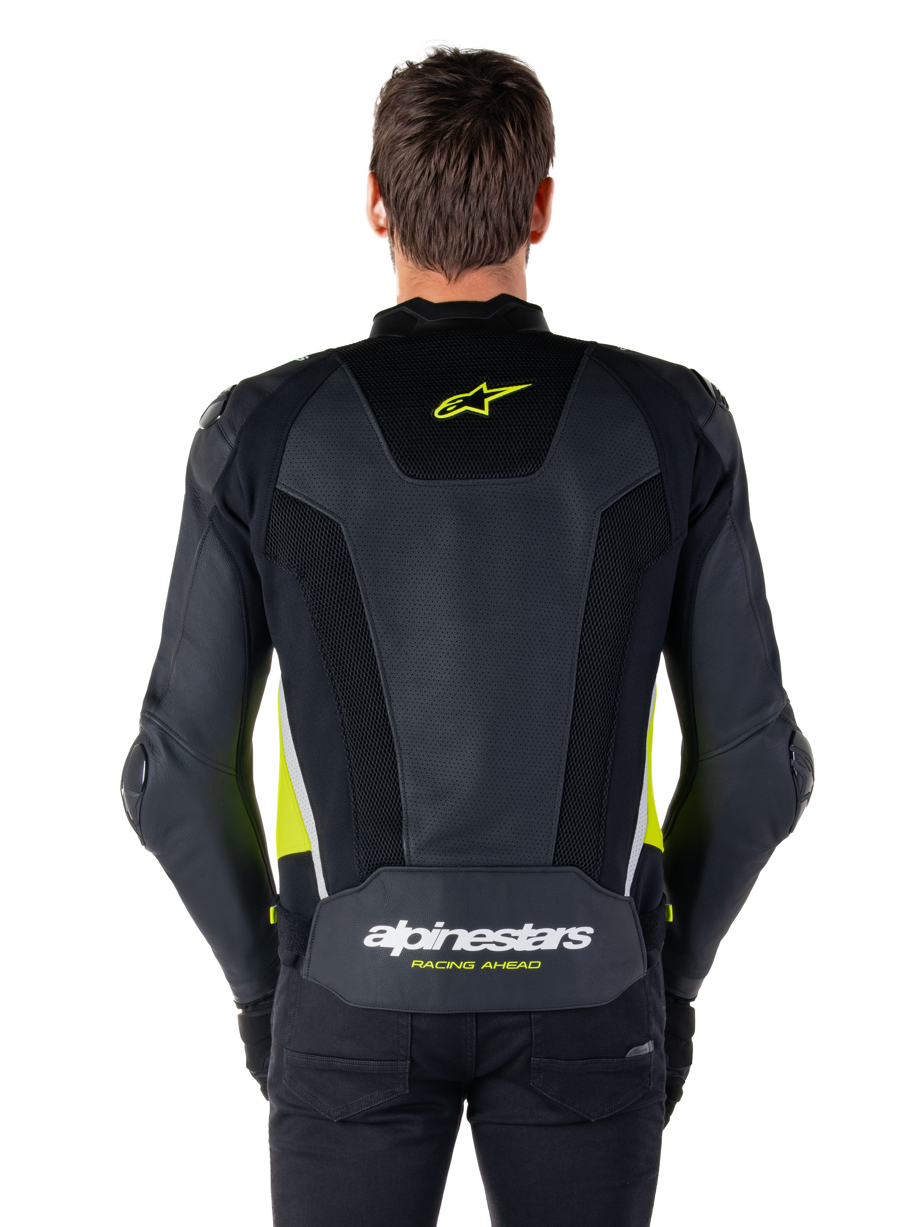 Alpinestars Missile V3 Airflow läderjacka, vy bakifrån, svart med detaljer i gul fluo och vitt, omfattande perforerade läderpaneler för kylning, Alpinestars-logotyper på övre och nedre delen av ryggen, racinginspirerad sportjacka för motorcykel