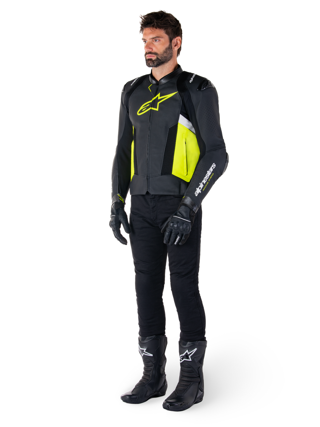 Manlig modell iklädd Alpinestars Missile V3 Airflow Läderjacka i svart, gul fluo och vitt, stylad med svarta körhandskar, byxor och stövlar, vilket framhäver den perforerade läderdesignen och den racinginspirerade estetiken.