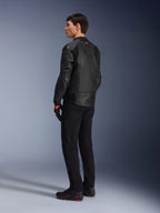 Alpinestars GP Plus R V4 Airflow Leather Jacket, Men's Sport Motorcycle Jacket, All Black, three-quarter rear view on a model, featuring perforated leather panels, red logo on the back, and integrated shoulder protection, worn with black pants and riding shoes