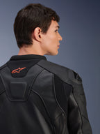 Alpinestars GP Plus R V4 Airflow Leather Jacket, Black, close-up rear view on a model, featuring perforated race-grade leather, technical stretch panels, and a small orange Alpinestars logo on the collar, professional motorcycle riding apparel