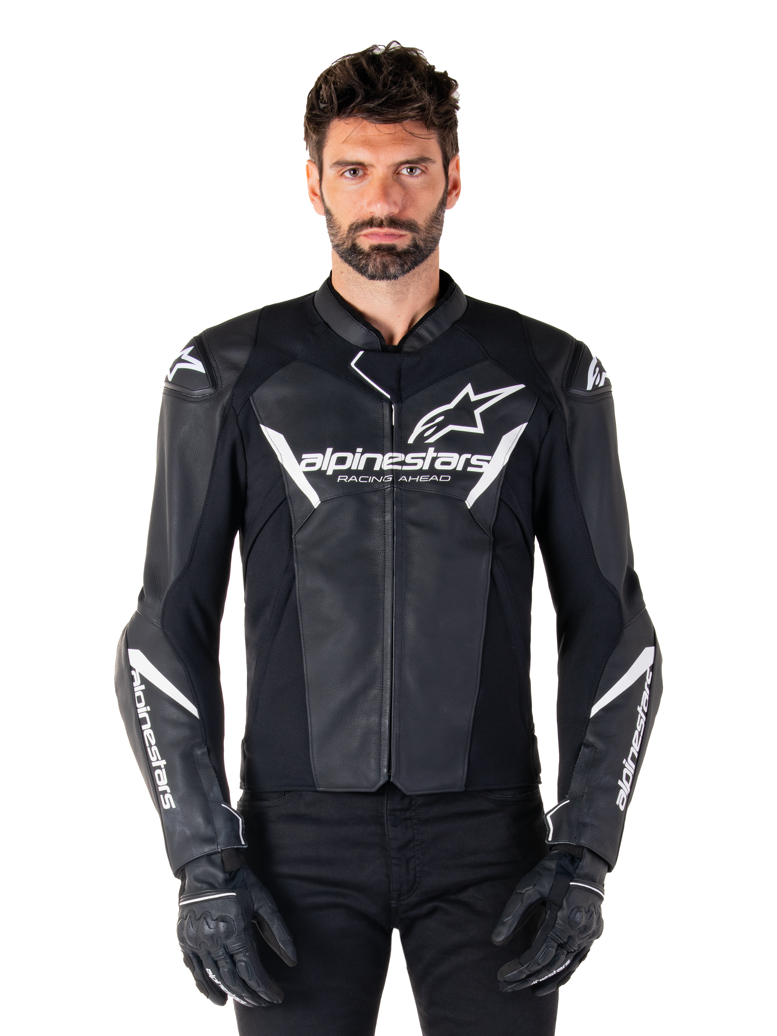 Alpinestars Faster V3 Leather Jacket, svart och vit motorcykeljacka för racing, med framträdande vita logotyper och brösttexten 'Racing Ahead', stilren läderdesign med vinklade detaljer på ärmarna, bärs med svarta racinghandskar